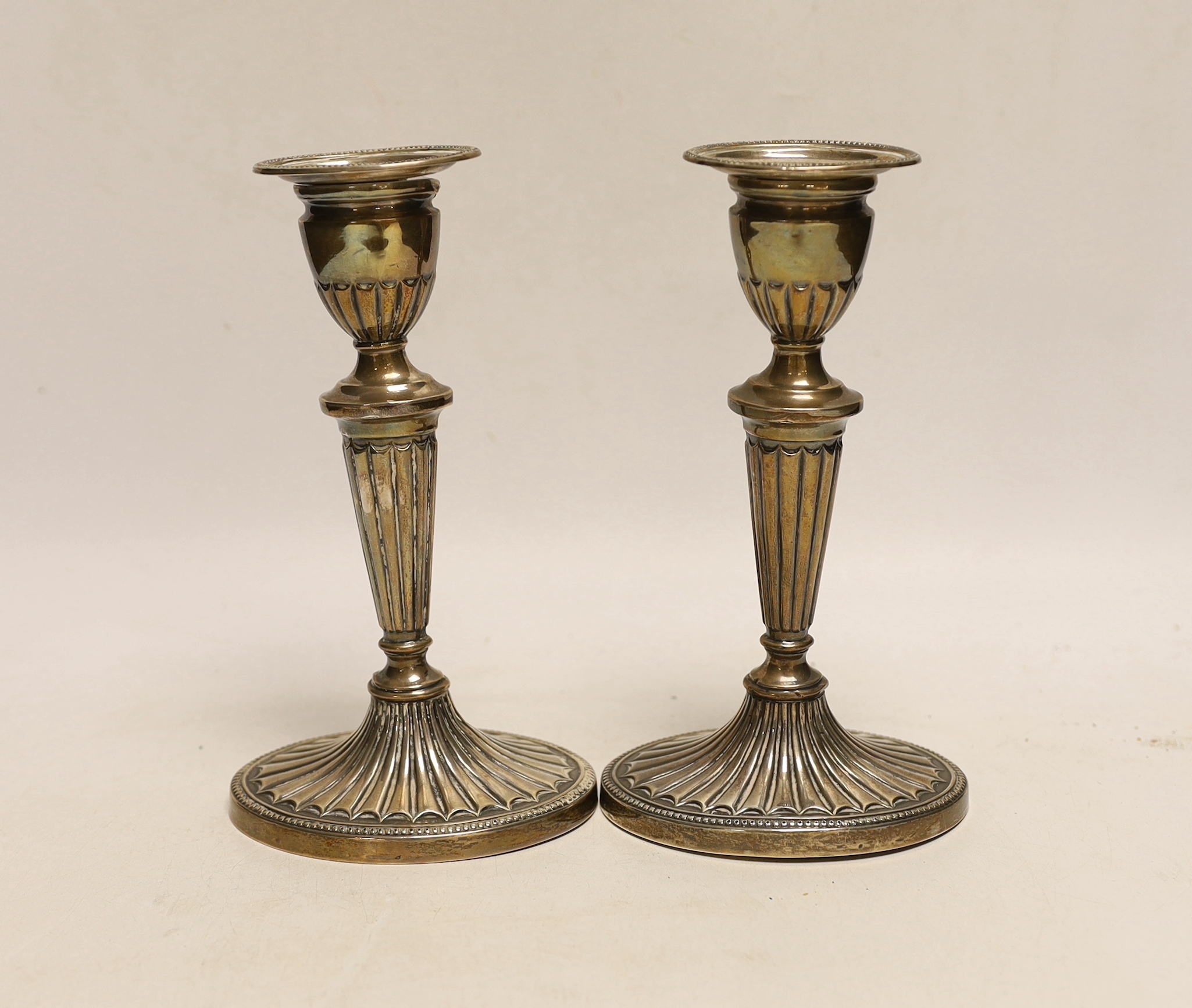 A pair of Edwardian silver mounted oval candlesticks, Barnett Henry Abrahams, Birmingham, 1908, 18.2cm, weighted.